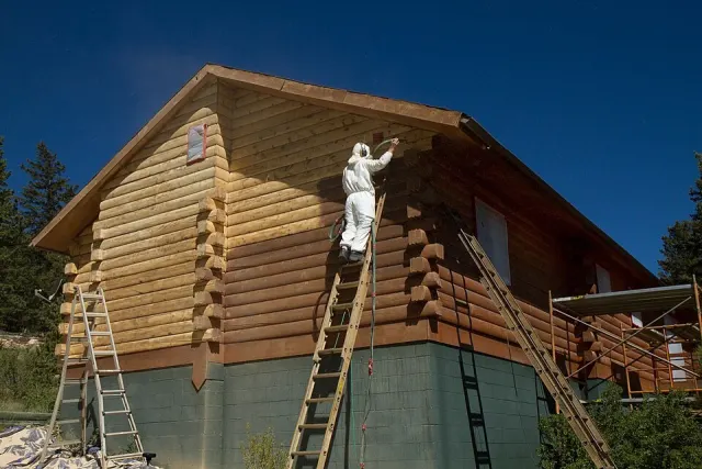 Cabin exterior work from ladders