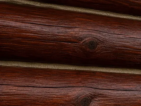 Close-up of the same log cabin wall with fresh deep burgundy-brown stain